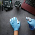 a dirty desk being cleaned by a janitor